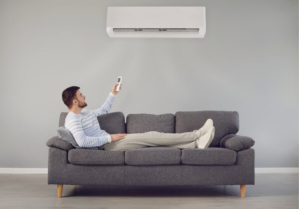 healthy-homes Christchurch NZ man adjusting air con temperature